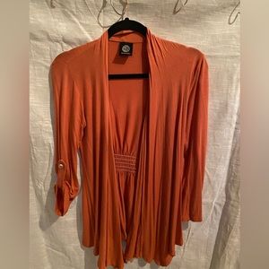 Bandeau Cardi burnt orange size Small. Flares at waist in front, gather in back